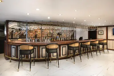 a bar in a restaurant with stools around it at Golden Age Hotel Taksim in Istanbul