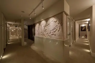 a hallway in a museum with a relief on the wall at Golden Age Hotel Taksim in Istanbul