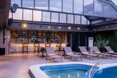 a patio with a bar and a swimming pool at Golden Age Hotel Taksim in Istanbul