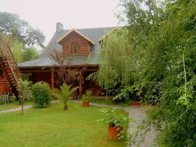 a house with a yard in front of it at Tranquilla River Lodge in Agva