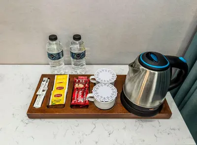 a tray with a coffee maker and two bottles of water at Tilia Hotel in Istanbul