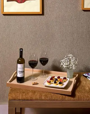 a table with two glasses of wine and a plate of food at Avantgarde Urban Levent in Istanbul