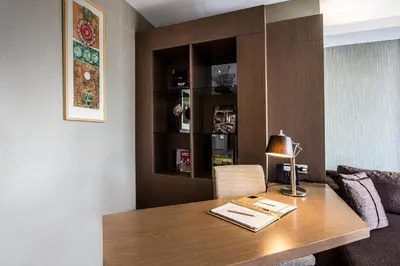 a room with a wooden table with a lamp on it at Avantgarde Urban Levent in Istanbul