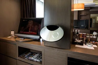 a room with a desk with a lamp and a television at Avantgarde Urban Levent in Istanbul