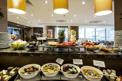 a buffet line with bowls of fruit and vegetables at Avantgarde Urban Levent in Istanbul