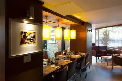 a dining room with a long table and chairs at Avantgarde Urban Levent in Istanbul