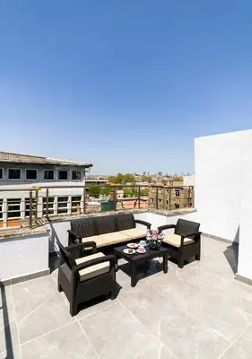 a patio with couches and a table on a roof at Cheers Vera Edition Hotel in Istanbul