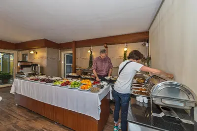 a man and a woman preparing food in a kitchen at The Empress Theodora Hotel in Istanbul