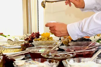 a chef preparing a buffet of food on a table at The Empress Theodora Hotel in Istanbul