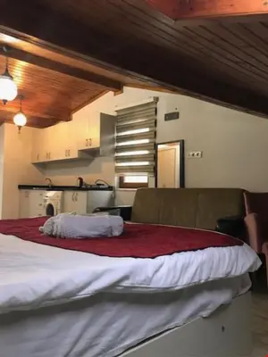 a large bed in a room with a kitchen at Taksim Sem House in Istanbul
