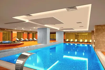 a large swimming pool in a hotel lobby at The Green Park Pendik in Istanbul