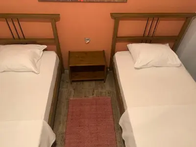two beds in a room with a table between them at Volare Apart in Istanbul