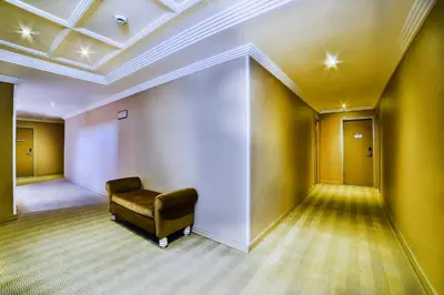 a waiting room with a chair in a room with yellow walls at Hotel Grand Emin in Istanbul