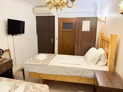 a bedroom with a bed with a wooden door at Magnificent Hotel in Istanbul