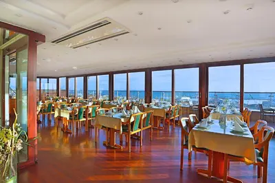 a dining room with tables and chairs and windows at Grand Madrid Hotel in Istanbul