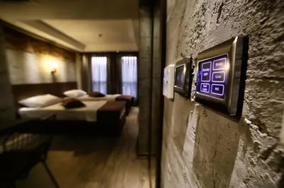 a room with two beds and a clock on the wall at Elibol Hotel Old City in Istanbul