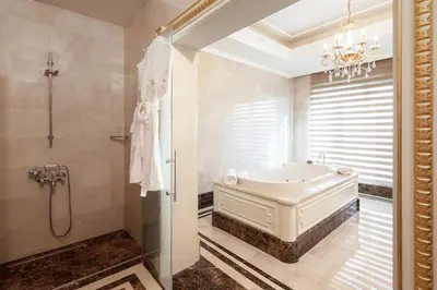 a bathroom with a tub and a shower and a chandelier at Crowne Plaza Istanbul Asia by IHG in Istanbul
