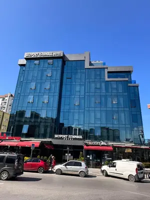 a large glass building with cars parked in front of it at Skyport Istanbul in Istanbul