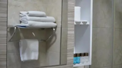 a pile of towels in a bathroom with a mirror at Skyport Istanbul in Istanbul