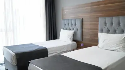 a hotel room with two beds and a window at Skyport Istanbul in Istanbul
