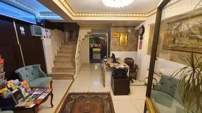 a lobby with a staircase and chairs and a table at Sultanahmet Park Hotel in Istanbul