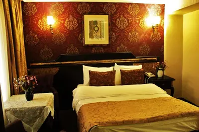 a bedroom with two beds and a red wall at Sultanahmet Park Hotel in Istanbul