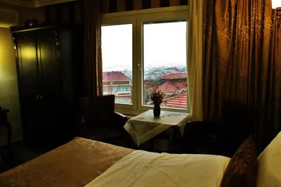 a bedroom with a window and a table and a bed at Sultanahmet Park Hotel in Istanbul
