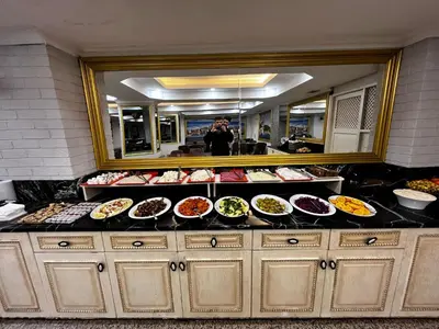 a person taking a picture of a buffet of food at Seher HOTEL in Istanbul