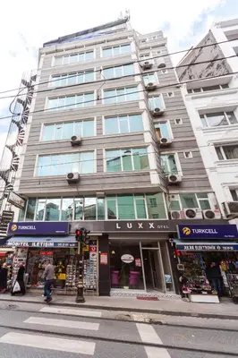a tall building on a city street with a store at Omega Luxx Hotel in Istanbul