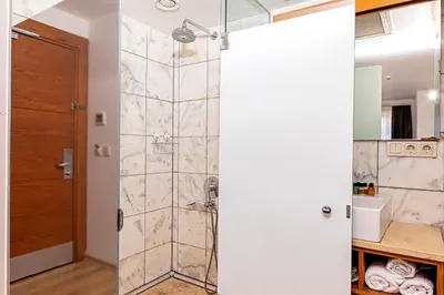 a shower with a glass door in a bathroom at Neda in Istanbul