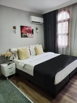 a bedroom with a large bed and a window at Antik Ipek Hotel in Istanbul