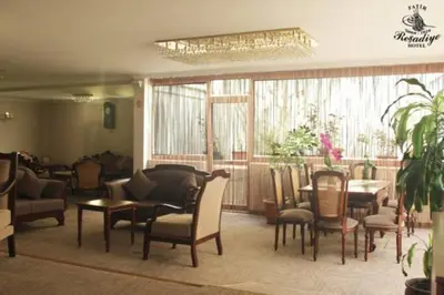 a lobby with chairs and tables and a dining room at Fatih Resadiye Hotel in Istanbul
