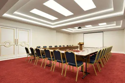 a conference room with a long table and chairs at Ramada by Wyndham Yalova in Yalova