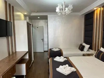 a hotel room with two beds and a television at Nova Roma Hotel in Istanbul