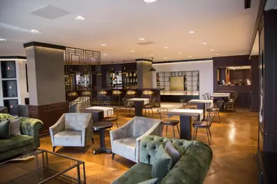 a lobby with couches and tables and a bar at Dila Hotel in Istanbul