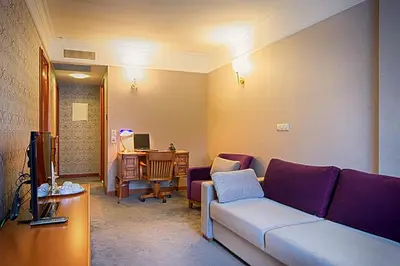 a living room with a couch and a desk at Dila Hotel in Istanbul