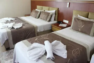 a hotel room with two beds with towels on them at Hermanos Hotel in Istanbul