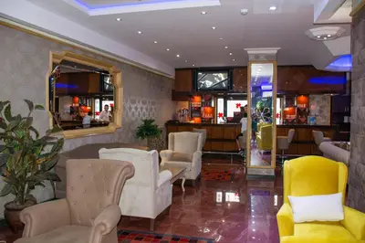 a lobby with white chairs and a bar at Hermanos Hotel in Istanbul