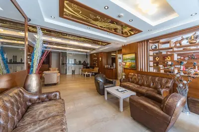 a living room with leather couches and a table at Senabil Hotel Old City & Spa in Istanbul