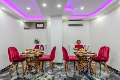 a dining room with two tables and red chairs at Hotel Silviya in Istanbul