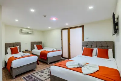 two beds in a room with orange and white at Hotel Silviya in Istanbul