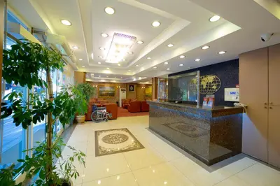 an office lobby with a reception counter and plants at Grand Unal Hotel in Istanbul
