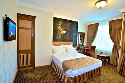 a hotel room with a bed and a television at Grand Unal Hotel in Istanbul