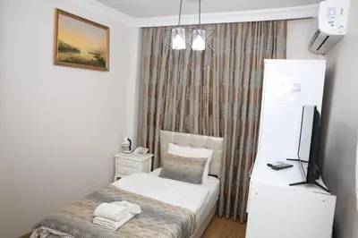 a small room with a bed and a television at Rosalie Palace Hotel in Istanbul