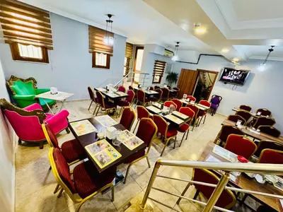 a restaurant with tables and chairs in a room at Rosalie Palace Hotel in Istanbul