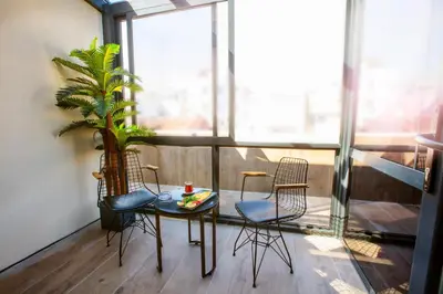 a balcony with a table and chairs and a plant at Endican Beyazit Hotel in Istanbul