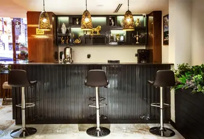 a bar with three stools in a restaurant at Endican Beyazit Hotel in Istanbul