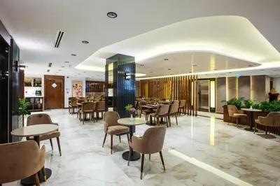 a restaurant with tables and chairs in a lobby at Endican Beyazit Hotel in Istanbul