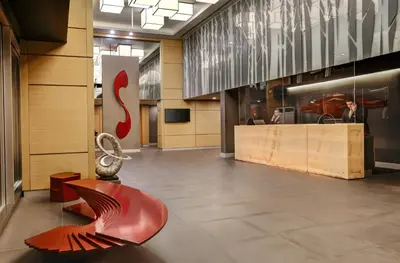 a lobby with a red bench in a building at Divan Corlu in Corlu