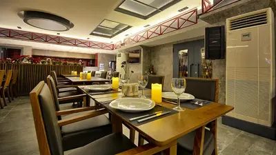 a restaurant with a long wooden table and chairs at Samir Deluxe Hotel in Istanbul